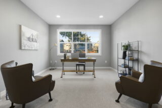 A modern home office with a desk, two chairs, shelf unit, artwork on the wall, and view of the exterior through a large window.